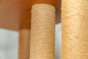 Close up of Sisal Rope Cat Scratching Post on Wooden Furniture.  Pet Accessory, Eco Friendly Material, Feline Behavior, Home Interior, Cat Furniture, Natural Texture, Modern Pet Care Design