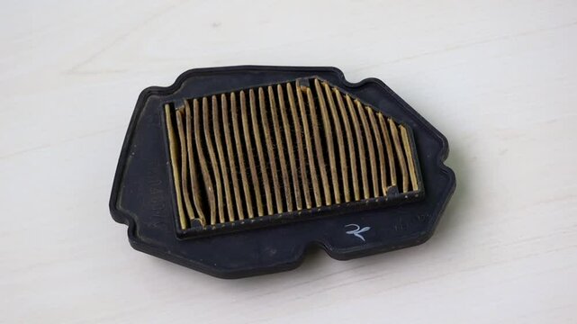 Dusty motorcycle air filter after extended use.