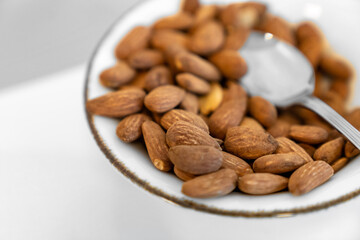 Healthy Snack Platter with Walnuts and Dried Fruits. Gourmet Organic Food, Clean Eating, Plant-Based Protein, Vegan Diet, Close Up of Nuts and Apricots in Elegant Silver Bowls