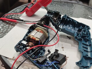 disassembled electric drill motor. repairing a broken electric drill motor. electrical mechanisms...