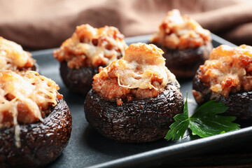 Delicious stuffed mushrooms with parsley on table, closeup
