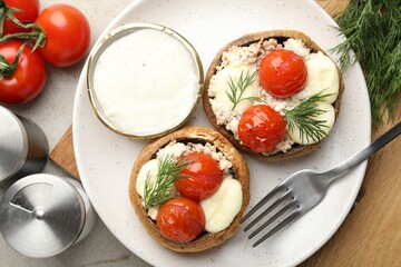 Tasty stuffed mushrooms served on light table, flat lay