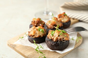 Tasty stuffed mushrooms served on light table, closeup