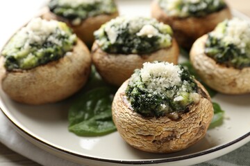 Tasty stuffed mushrooms served on table, closeup