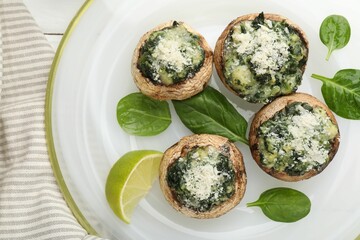 Tasty stuffed mushrooms served on white table, top view