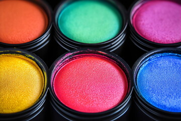 Vibrant hues of creativity burst forth from containers of artistic pigments, promising inspiration in every shade of color