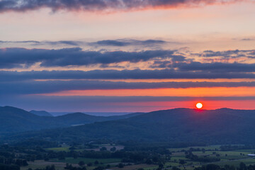 Colorful sunset over rolling hills creating a beautiful landscape