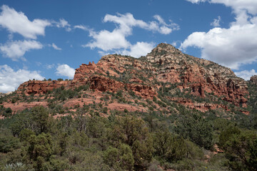 Sedona, Arizona, red rock formations and scenic landscapes under dramatic cloud-filled skies, capturing the natural beauty of the desert wilderness.