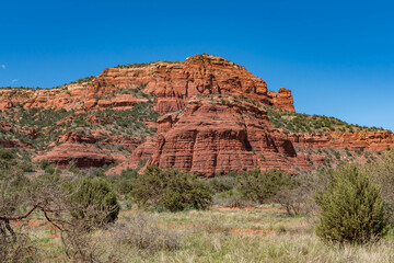 Sedona, Arizona, red rock formations and scenic landscapes under dramatic cloud-filled skies, capturing the natural beauty of the desert wilderness.