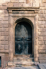 Antique Black Door in Old Stone Building