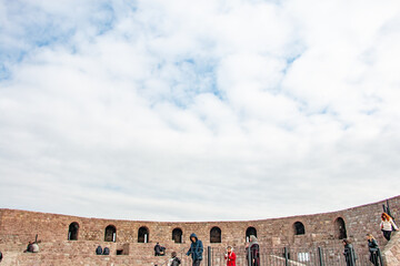 Ancient Stone Amphitheater Under a Cloudy Sky