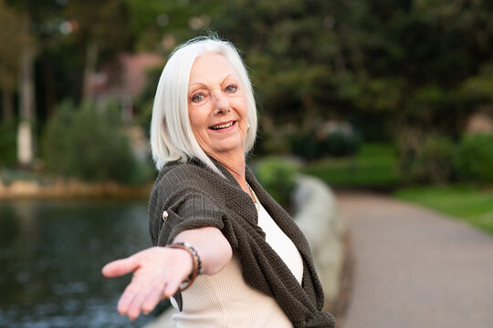senior woman holding her hand back to the camera