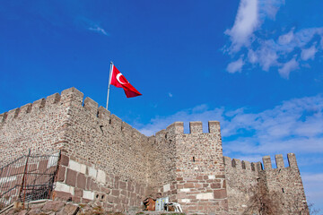 Turkish Flag Waves Over Ancient Stone Castle: Majestic View