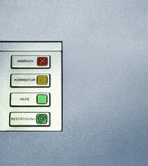 Macro shot of four function keys on an ATM interface labeled in German. Abbruch Cancel, Korrektur...
