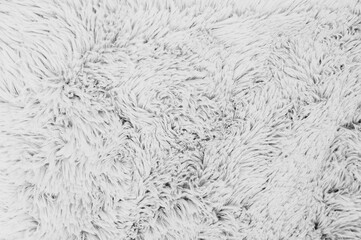 An elegant close-up showcases the soft texture of a fluffy white fabric, perfect for backgrounds.