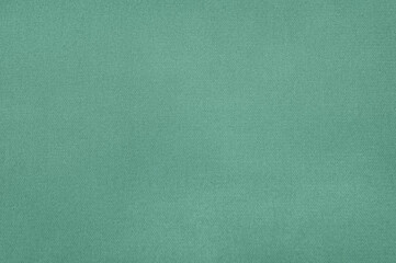 A calming teal fabric fills the frame, showcasing the subtle texture and inviting feel of the cloth.
