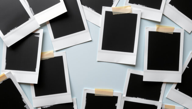 Empty photo frames scattered on light blue background create nostalgic and creative atmosphere, inviting memories