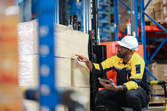 Warehouse scene with forklift driver assessing boxes and using technology for efficient logistics and warehouse operations tracking...