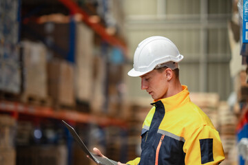 Manager performs a routine inventory audit, typing findings on a laptop while reviewing goods....
