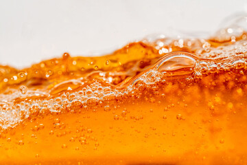 Close up bright orange Oil or beer splash texture and nature waves, Beautiful waves curve and little bubbles smooth for graphic design and background, Oil Bubbles, Soft beer bubbles, Selective focus