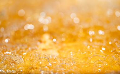Close up bright orange Oil or beer splash texture and nature waves, Beautiful waves curve and little bubbles smooth for graphic design and background, Oil Bubbles, Soft beer bubbles, Selective focus
