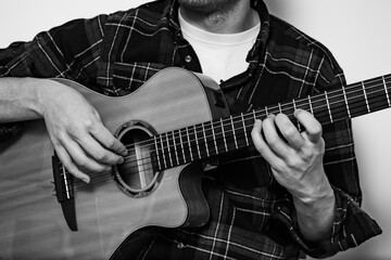 A black-and-white shot captures a classical guitarist in fingerstyle—timeless, emotive, and...
