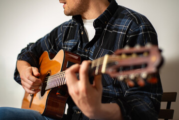 Warm studio lighting highlights a classical guitarist mid-performance, fingers flowing over the...