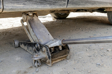 Tire fitting process, trolley jack lifts the car