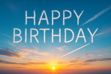青空に描かれた「HAPPY BIRTHDAY」の文字と朝日