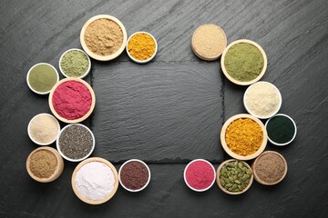Frame of different superfood powders on black table, flat lay. Space for text