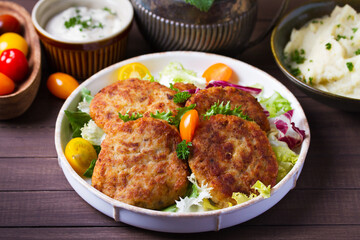 Fish cakes with vegetables and mashed potatoes. Fish patties or burgers