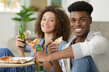 couple bonding on box of pizza and beer