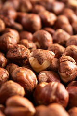 raw whole hazelnuts closeup, brown shells, natural snack, food texture