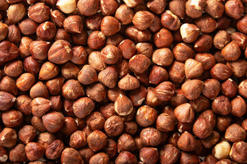 raw whole hazelnuts closeup, brown shells, natural snack, food texture