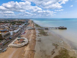 Drone aerial view of Worthing Pier and the beach of the city. Worthing is a seaside town and borough in West Sussex, England.