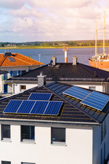 Modern house roof equipped with solar panels is visible during the day showing eco friendly power...