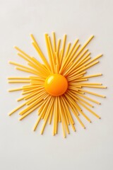 Spaghetti strands arranged like sunrays, radiating from cracked egg yolk, modern food concept
