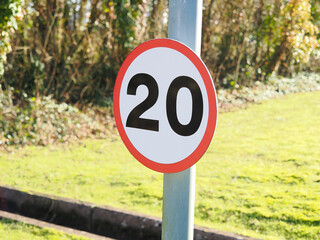 close up of a UK maximum road speed limit sign showing 20 mph as the top speed