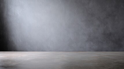 Minimalist gray cement wall with soft lighting, evoking simplicity and modern abstraction.
