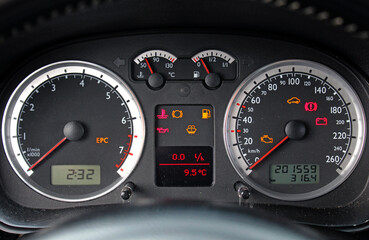 Fototapeta premium Close up of car dashboard. Error signs on car dashboard. Red and yellow car error signs. Car instrument panel - speedometer, tachometer.