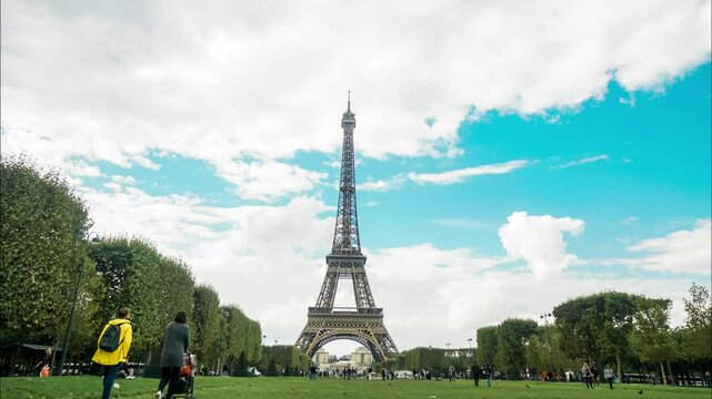 A captivating image of the Eiffel Tower surrounded by lush greenery and a bright blue sky