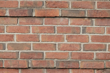 Obraz premium Classic red brick wall with visible mortar lines and uniform layout