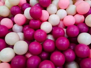 Dozens of white and pink balls in one place