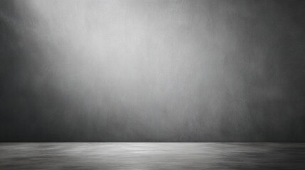 Minimalist gray cement wall with soft lighting, evoking simplicity and modern abstraction.
