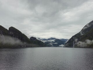 Fjord, mist, clouds and waterfalls in Norway