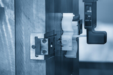 The automotive parts production process by plastic injection mold machine in the light blue scene.