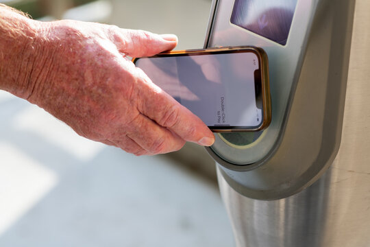 man tapping on for public transport with his phone