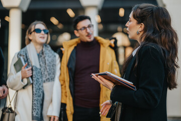 Group of young business professionals engaging in a brainstorming session within a cityscape environment, indicating collaboration, teamwork, and creative business idealization in a modern urban