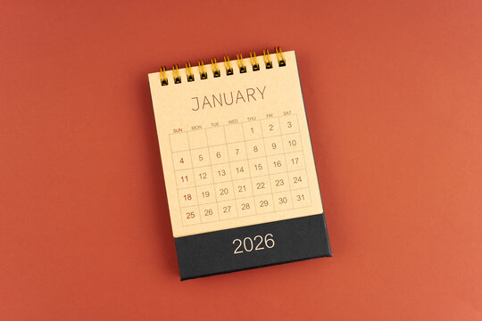 January 2026 calendar from brown craft paper on red background.