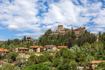 The medieval village of Montecatini Alto, located in the province of Pistoia in Italy, is nestled atop a hill and showcases its beautiful medieval architecture surrounded by lush greenery.